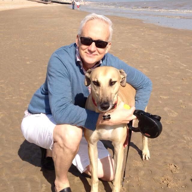 Paul with William, his fawn racing greyhound, on the beach